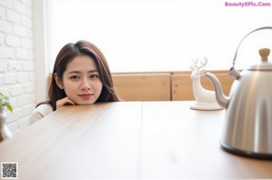 A woman sitting on a window sill in a room.