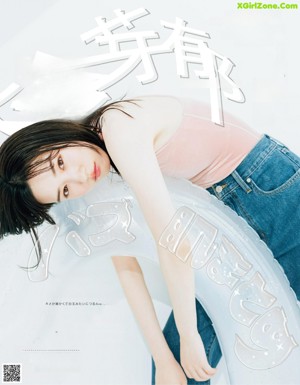 A woman in a green sweatshirt is posing for a magazine.