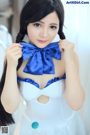 A woman in a black and white dress posing for a picture.