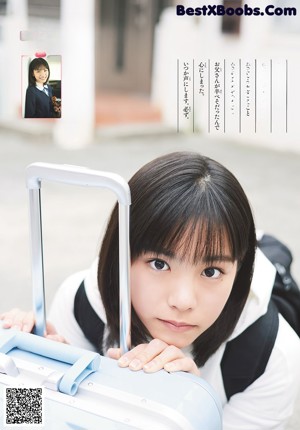 A young woman in a blue jacket is posing for a magazine.