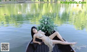 a woman in a bikini sitting on a boat
