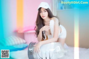 A woman sitting on top of a pink chair.