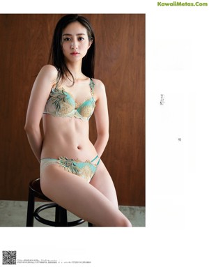 A woman in lingerie posing for a magazine cover.