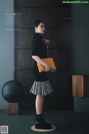 A woman sitting on top of a wooden box.