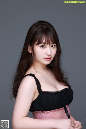 A woman in a black lingerie posing for a picture.