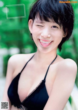A woman in a bikini standing in the water.